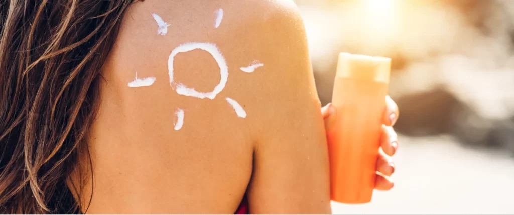 suntan lotion on woman's shoulder